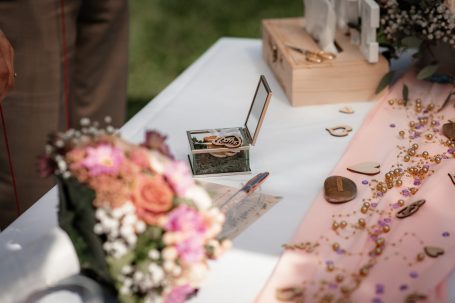 Ein Tisch mit Blumen, Schmuckstücken und Dekoration für eine Feier.